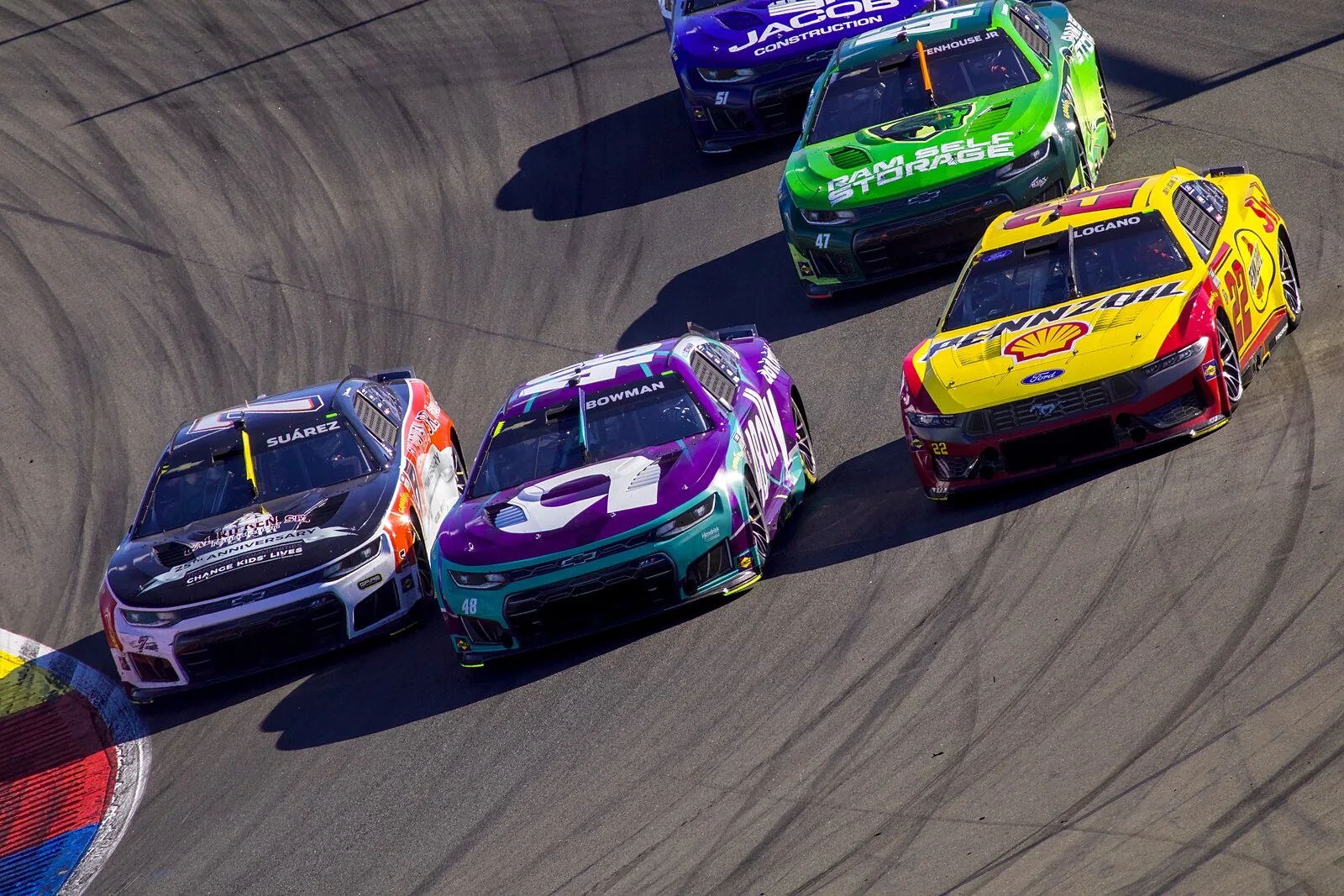 Daniel Suarez, Alex Bowman and Joey Logano battle at Watkins Glen in 2026