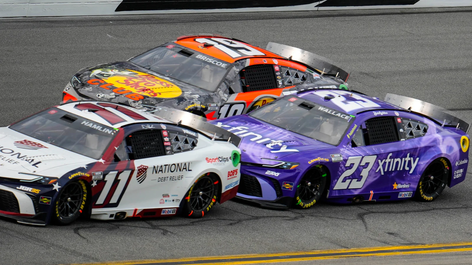 NASCAR Cup Series cars racing three-wide at Daytona International Speedway in 2026
