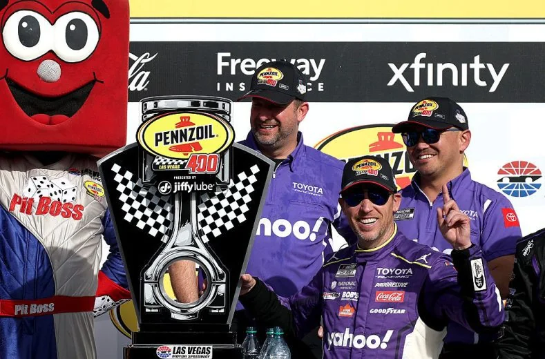 Denny Hamlin celebrating his 2026 Cup Series victory at Las Vegas Motor Speedway