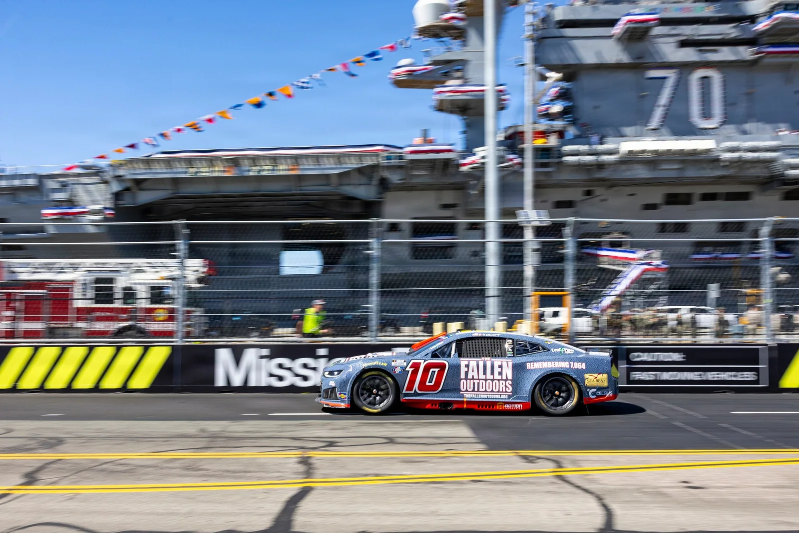 A modern NASCAR Cup car racing on a temporary street circuit